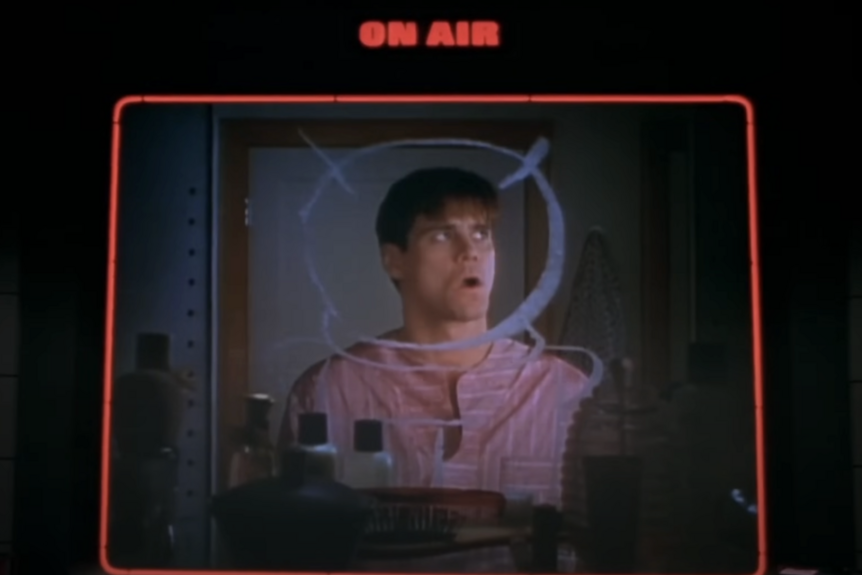 Truman Burbank (Jim Carrey) is seen through an "On Air" box in The Truman Show (1998).