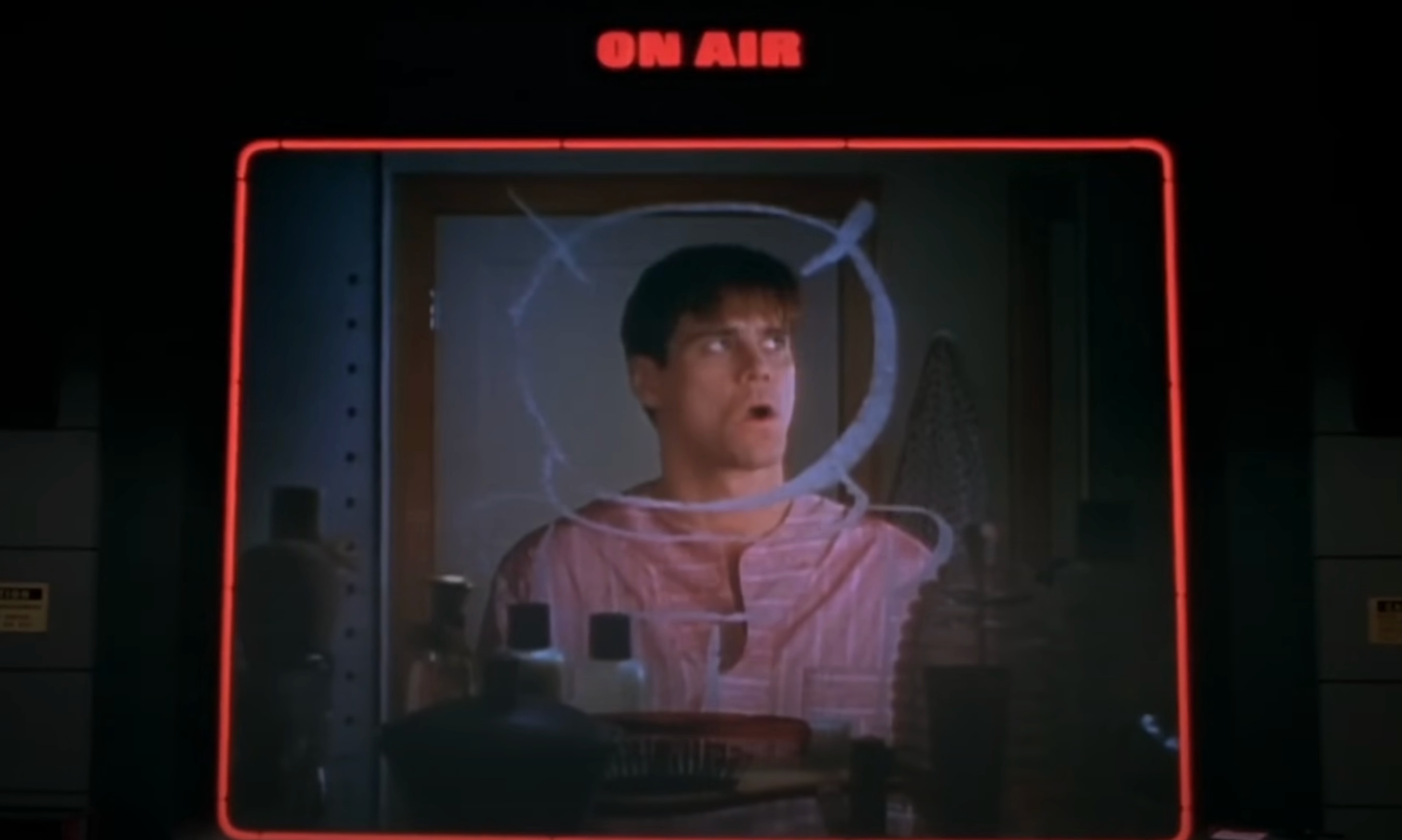 Truman Burbank (Jim Carrey) is seen through an "On Air" box in The Truman Show (1998).
