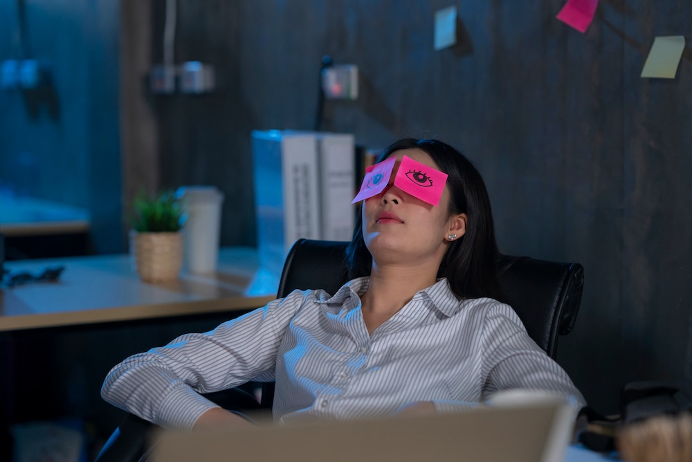 Young woman asleep in office.