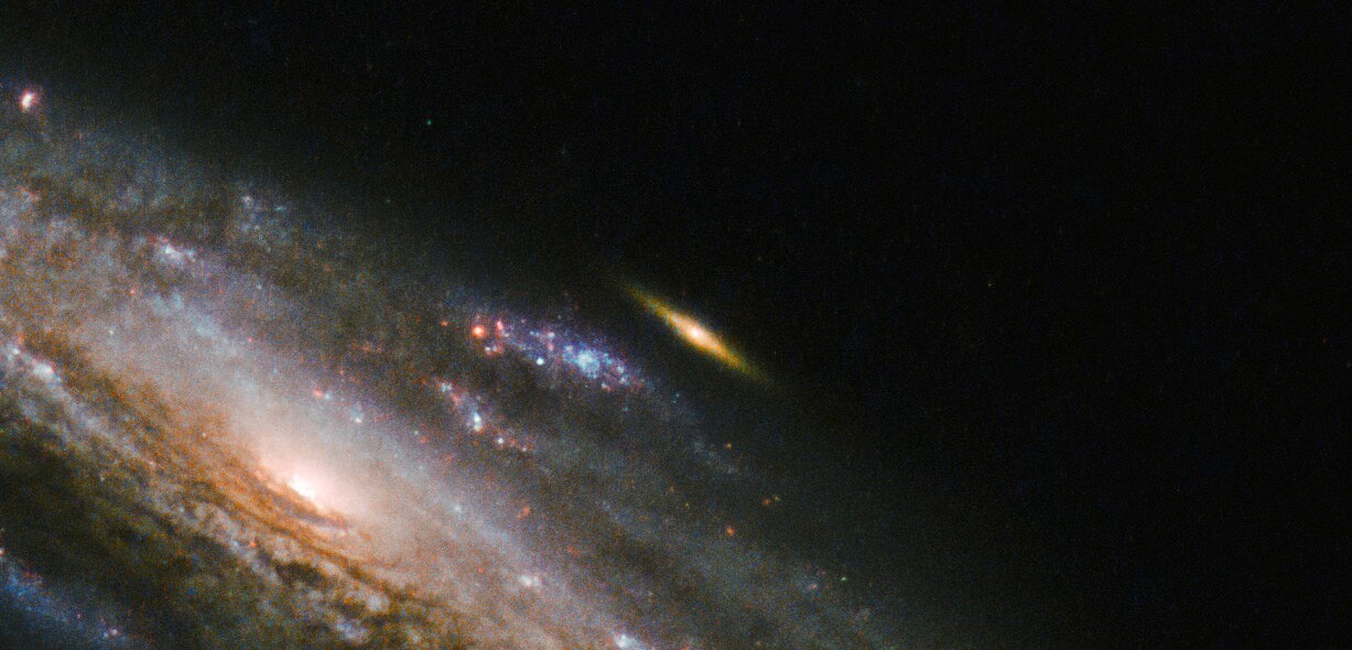 NGC 5559 and a little friend, imaged by Hubble Space Telescope. Credit: ESA/Hubble & NASA