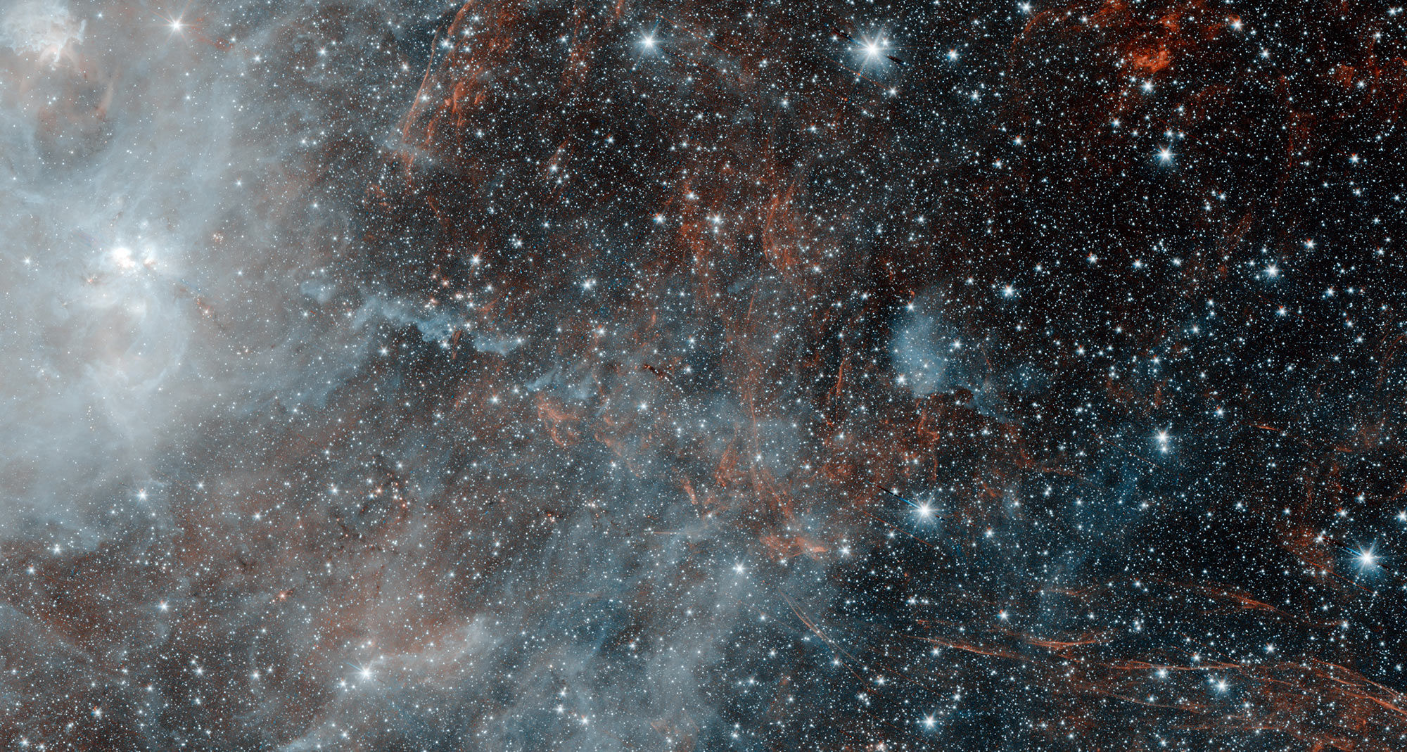 The supernova remnant HBH 3 can be seen as wispy red tendrils in this Spitzer Space Telescope image. The other objects are star forming regions. Credit: NASA/JPL-Caltech/IPAC