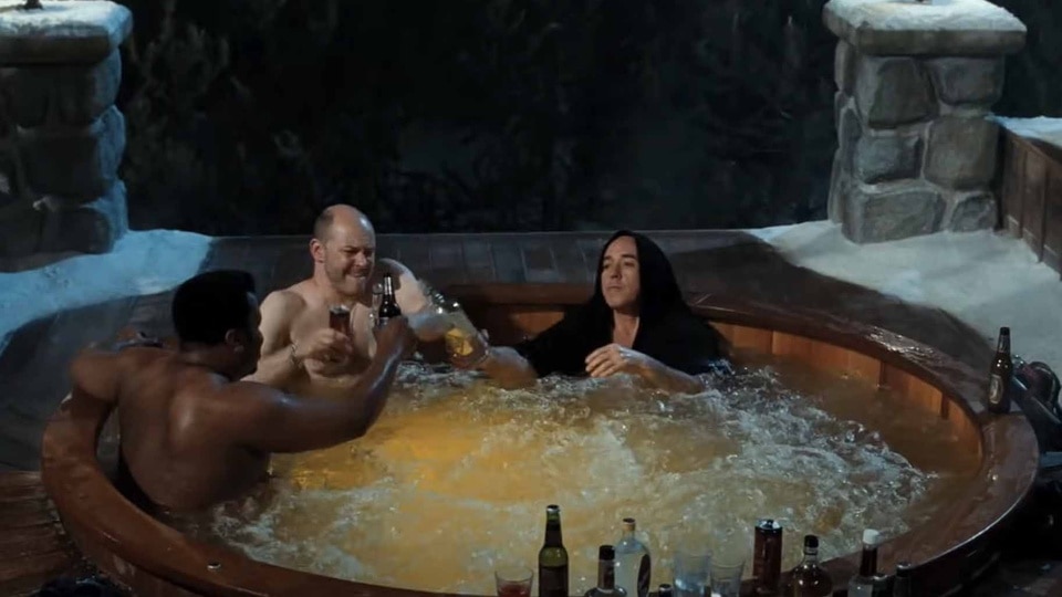 Nick Webber (Craig Robinson), Lou Dorchen (Rob Corddry), and Adam (John Cusack) cheers beers while sitting in a hot tub in Hot Tub Time Machine (2010).