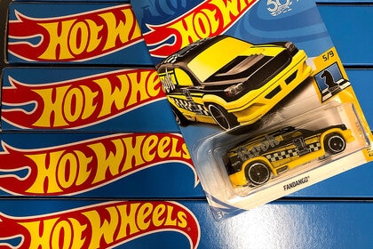 A taxi cab Hot Wheels in its packaging