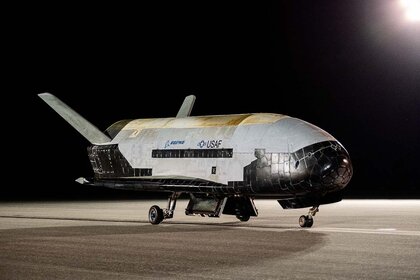 Space Force's X-37B Space Plane sits on the runway.