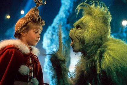 Cindy Lou Who (Taylor Momsen) wears Christmas gear and listens to The Grinch (Jim Carrey) lecture in How the Grinch Stole Christmas (2000).
