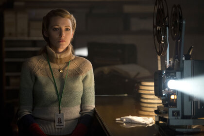Adaline (Blake Lively) stands near a cinema projector in The Age of Adaline (2024).