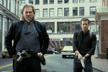Roicephus (Jeff Bridges) and Nick Walker (Ryan Reynolds) don weapons in R.I.P.D. (2013).