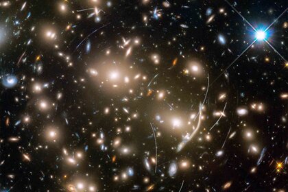 Abell 370 provides a dramatic backdrop for quite a few asteroids, seen as curved tracks in this Hubble image. Credit: NASA, ESA, and B. Sunnquist and J. Mack (STScI) Acknowledgment: NASA, ESA, and J. Lotz (STScI) and the HFF Team