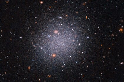 The ultra-diffuse dwarf galaxy NGC 1052-DF2, seen here using Hubble, apparently has little or no dark matter. It’s not clear how this happened. Credit: NASA, ESA, STScI, Zili Shen (Yale), Pieter van Dokkum (Yale), Shany Danieli (IAS) Image processing: Aly