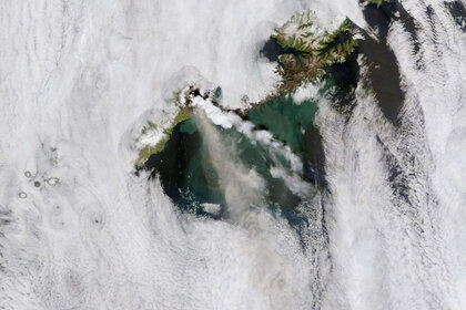 The 2008 eruption of Okmok seen from space by NASA’s Terra satellite. The steam cloud (white) is well over 100 km long, and an ash/gas cloud can be seen below it. Credit: NASA image courtesy MODIS Rapid Response team
