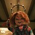 Chucky smiles murderously while holding a bloody knife in Chucky 303.