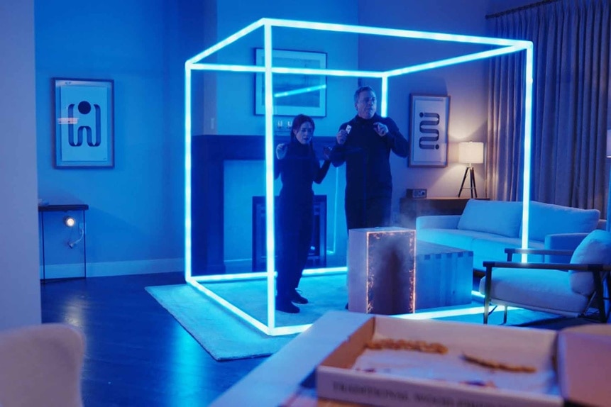 D'Arcy Bloom and Harry Vanderspeigle stand in a glowing blue cube in Resident Alien Episode 302.