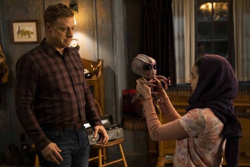 Harry Vanderspeigle watches Sahar hold Baby Alien on Resident Alien Season 3 Episode 7.