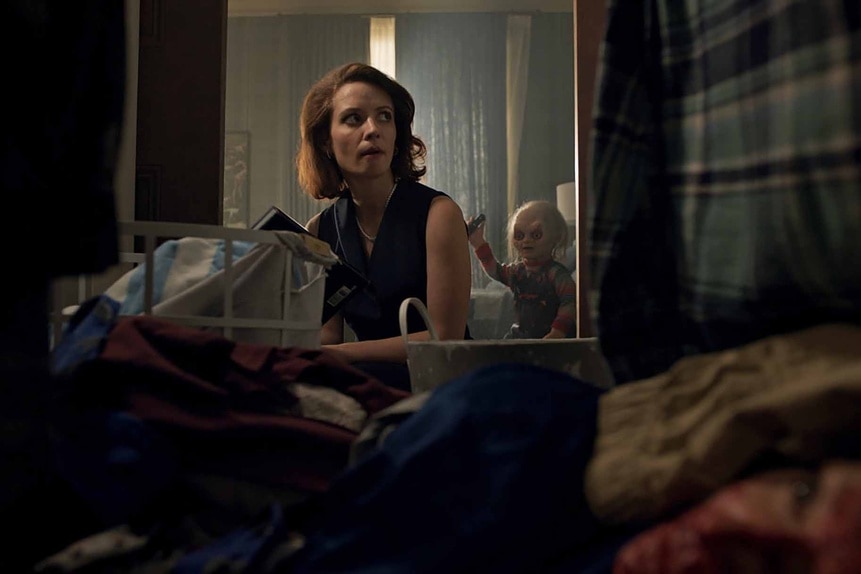 Chucky sneaks up behind Charlotte Collins (Lara Jean Chorostecki) in Chucky Episode 305.