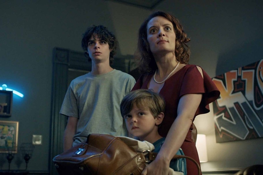 Grant Collin (Jackson Kelly), Henry Collins (Callum Vinson), and Charlotte Collins (Lara Jean Chorostecki) huddle together in Chucky Episode 306.