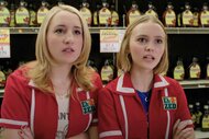 Collen McKenzie (Harley Quinn Smith) and Colleen Collette (Lily-Rose Depp) match red uniforms in front of a shelf of maple syrup in Yoga Hosers (2016).