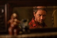 Paddy (James McAvoy) peers at toys in front of a mirror in Speak No Evil (2024).