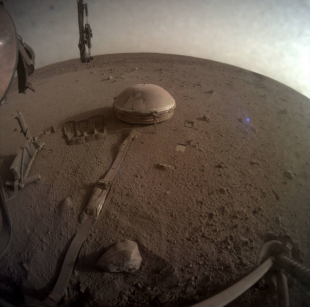 An image of NASA’s InSight Mars lander's seismometer on the Red Planet’s surface