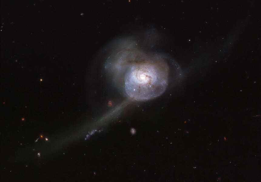 NGC 34 is a galaxy collision showing a classic tidal tail of stars and gas pulled away from one of the galaxies by the gravity of the other. Credit: ESA/Hubble & NASA, A. Adamo et al.