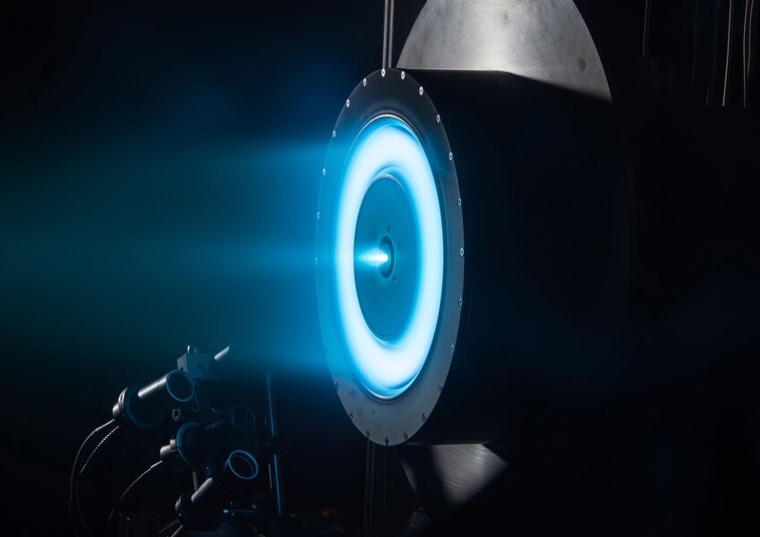 A typical ion drive uses xenon, which glows blue as the gas is blasted out the back. Credit: NASA