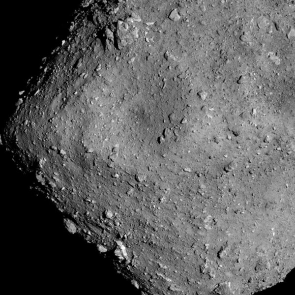 The asteroid Ryugu seen by the spacecraft Hayabusa 2 from a mere 6 kilometers away. The surface is strewn with rubble; objects just over a meter across are visible.