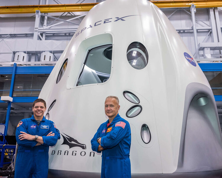 The SpaceX Demo-2 astronauts (Bob Behnken, left, and Doug Hurley, right) in front of their Crew Dragon capsule. Credit: NASA