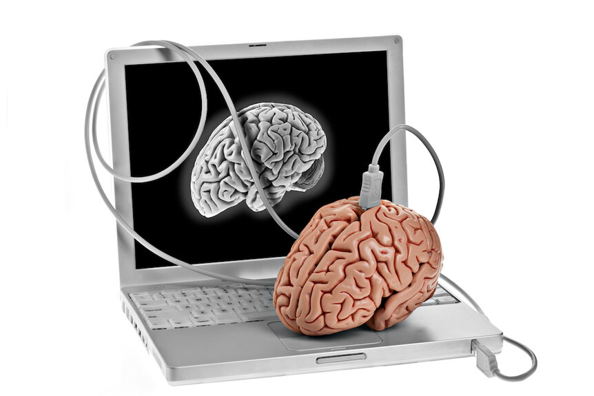 Computer plugged into a brain.