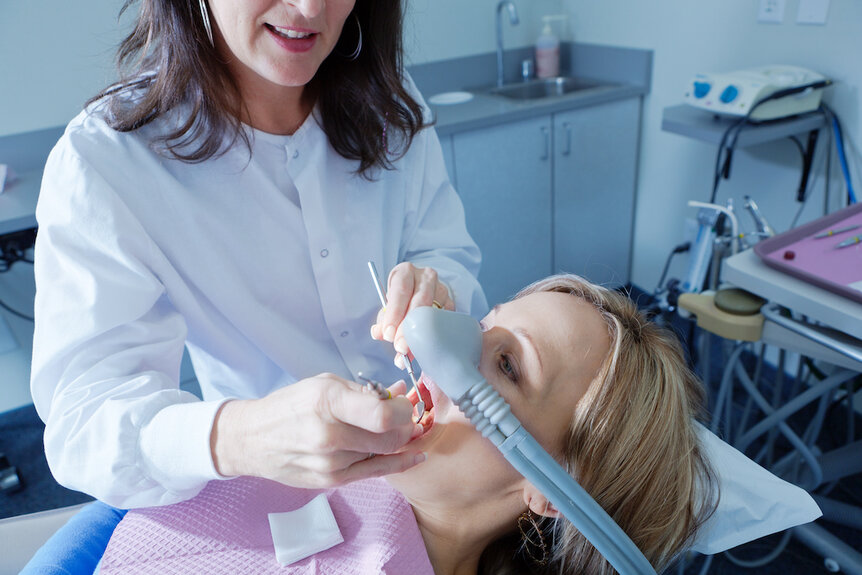 Dentist with patient in dental procedure
