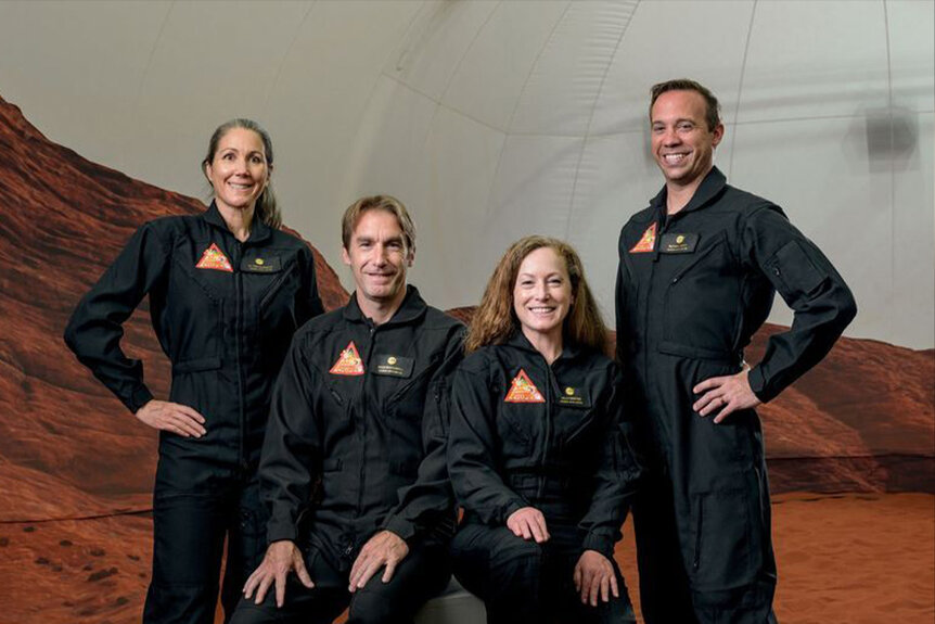 Crew of the first CHAPEA simulated Mars mission poses in front of a simulated Mars