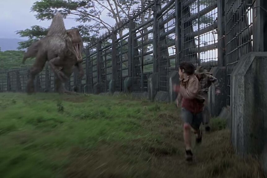 A Spinosaurus chases humans in the Jurassic Park film series.
