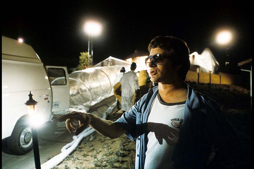 Director Steven Spielberg appears in sunglasses in front of the set for the film E.T. The Extra-Terrestrial (1982).
