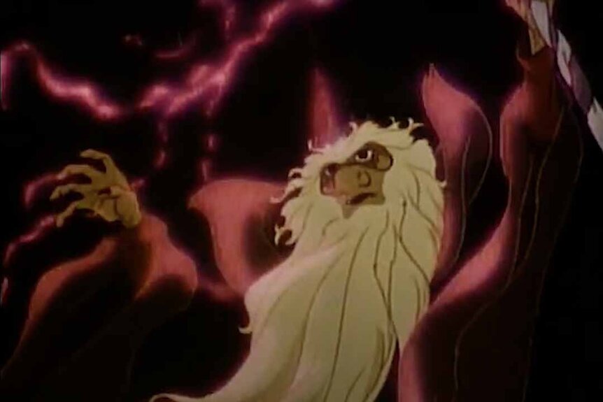 A wizard with a long blonde beard casts a spell with red smoke around him in The Last Unicorn (1982).