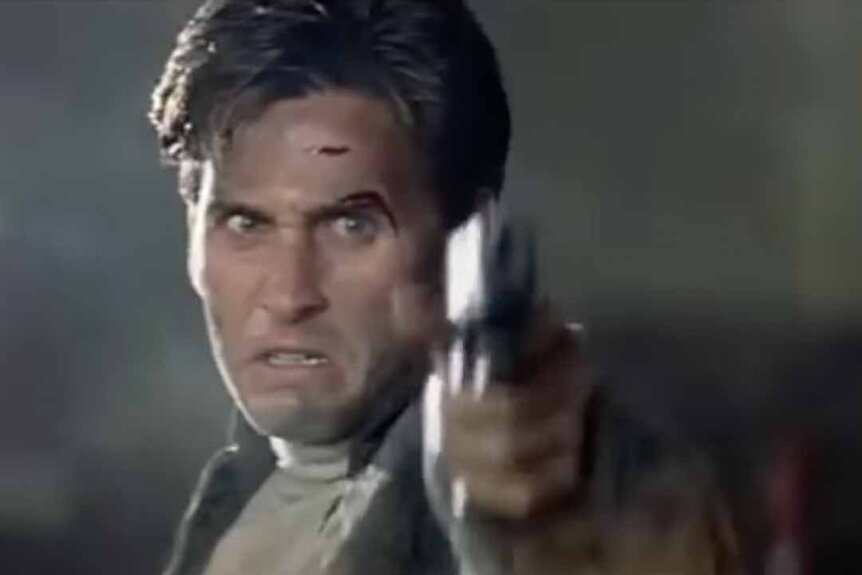 Alex Furlong (Emilio Estevez) fires a gun in Freejack (1992).