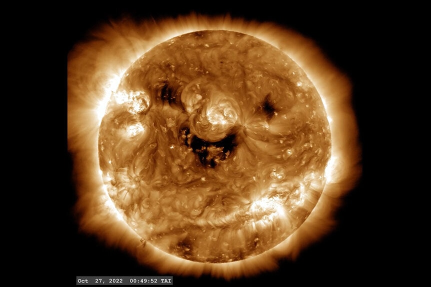Three coronal holes on the sun that looks like a smiling face