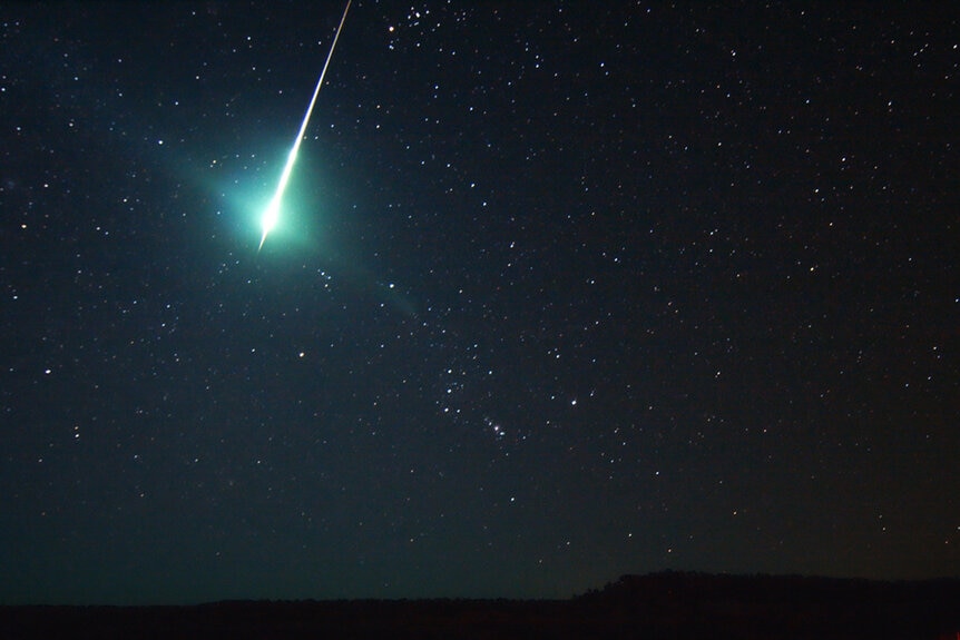 A fireball shooting across the night sky.