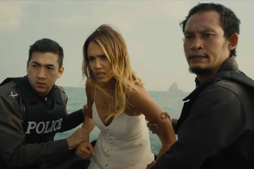 Gina (Jessica Alba) is held captive by two men wearing police vests in Mechanic: Resurrection (2016).