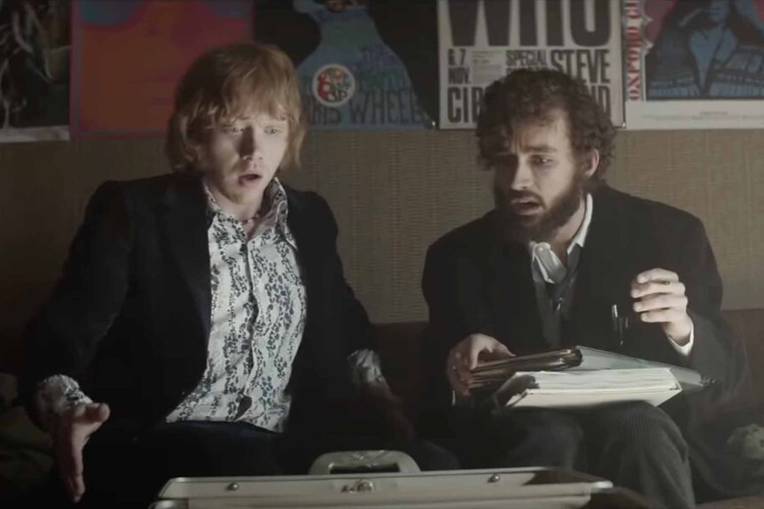 Jonny and Leon look down in awe at an open briefcase in Moonwalkers (2015).