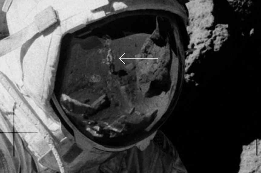 A close-up of Cernan's visor shows a figure standing there. Who could it be? Guess. Credit: NASA