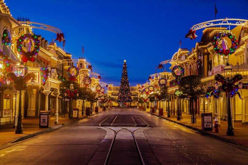 Main Street USA with a Christmas tree at the end decorated for the holiday 