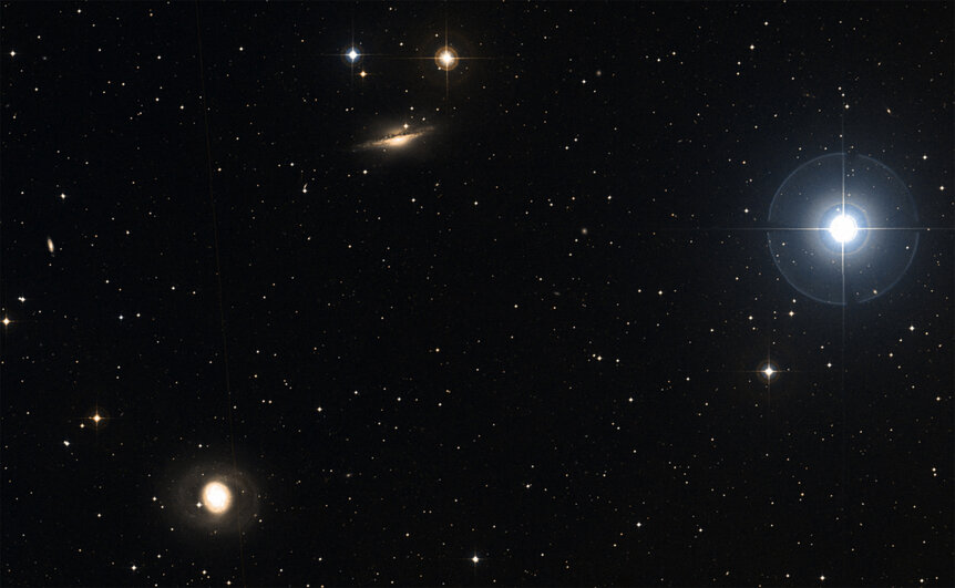 The area of the sky around NGC 1055 (center top) shows the bright star Delta Ceti (right) and another galaxy, M 77 (lower left). The two galaxies may have interacted in the past. Credit: SIMBAD / Aladin / DSS