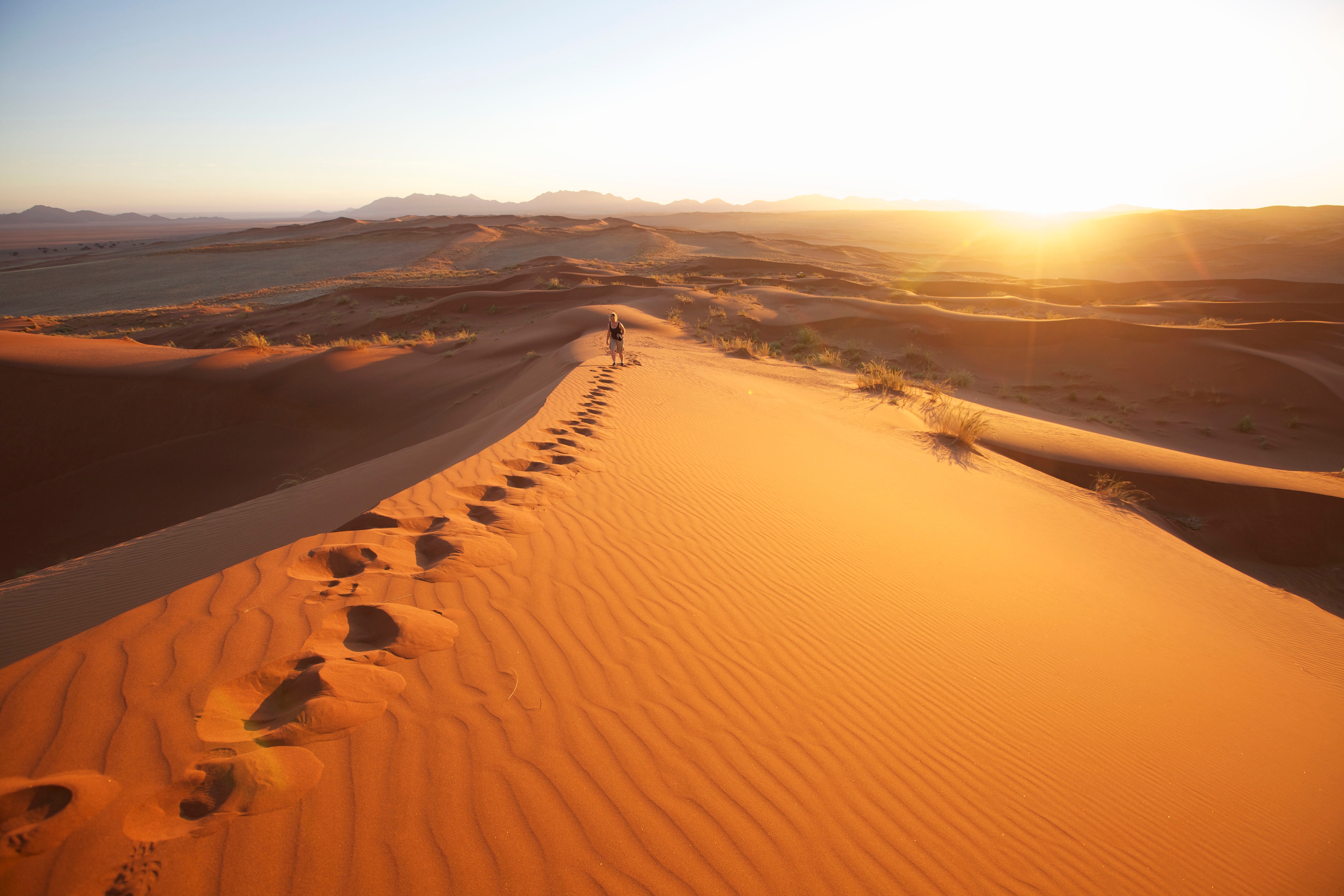 A person walking up a sand dune, Keetmashoop, Namibia Namibia, officially the Republic of Namibia, is a country in Southern Africa whose western border is the Atlantic Ocean. It shares borders with Angola and Zambia to the north, Botswana and Zimbabwe to 