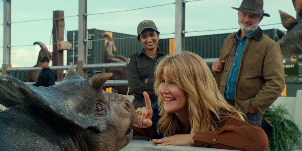 (from left) A baby Nasutoceratops, Dr. Ellie Sattler (Laura Dern) and Dr. Alan Grant (Sam Neill) in Jurassic World Dominion.