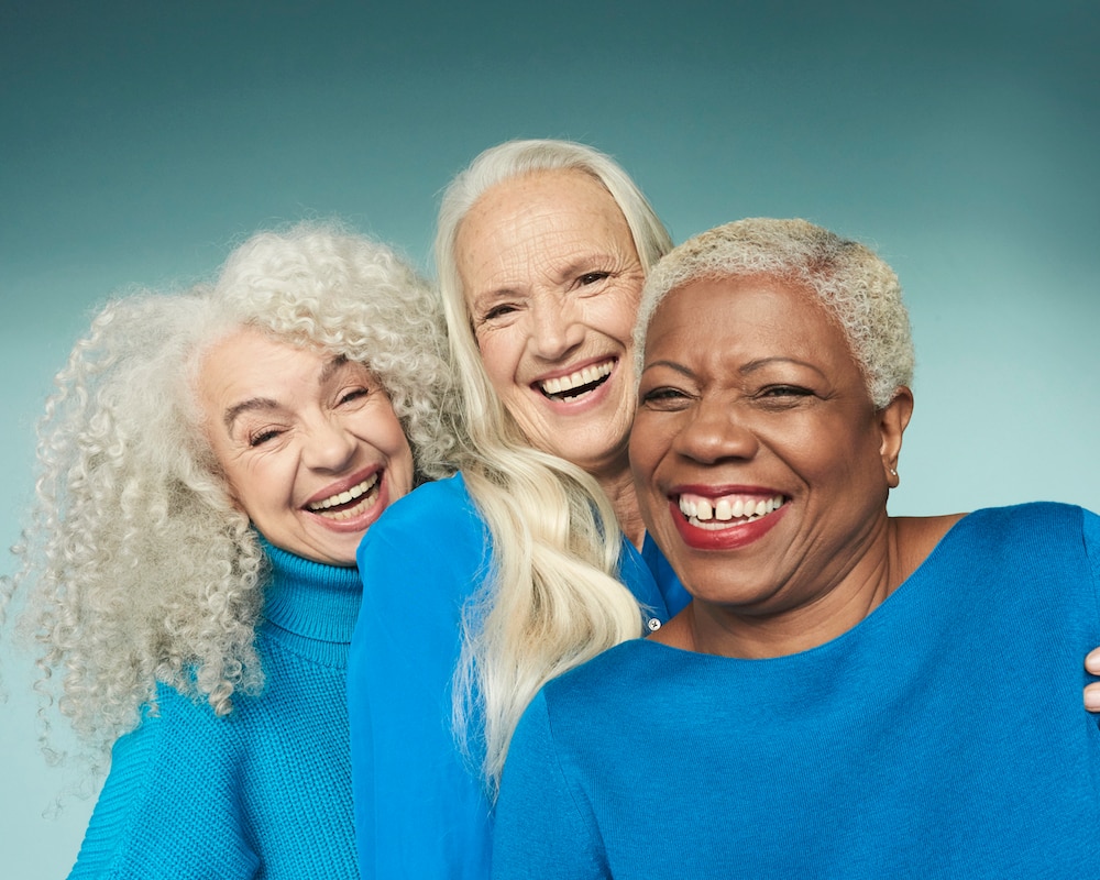 Group portrait of three mature women smiling