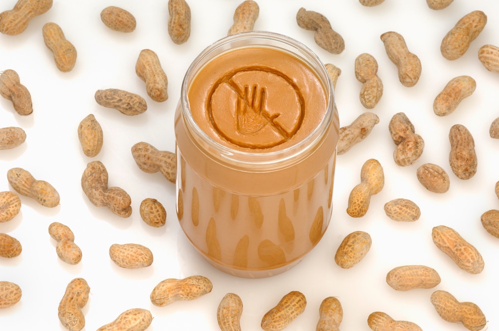 A concept photograph of a no entry or prohibited sign engraved into a jar of peanut butter.