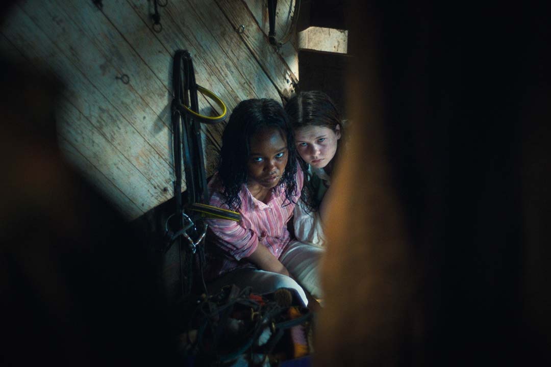 Angela Fielding (Lidya Jewett) is restrained as Katherine (Olivia Marcum) embraces her The Exorcist: Believer (2023).