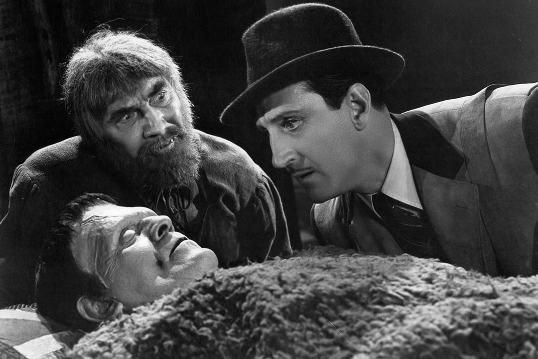Bela Lugosi and Basil Rathbone looking at their creation Boris Karloff in a scene from the film Son of Frankenstein (1939).