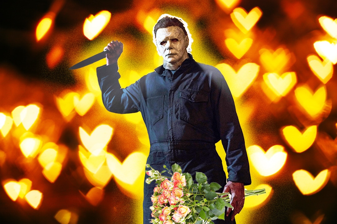 Nick Castle as Michael Myers in Halloween (2018) holds a bouquet of flowers in front of a heart bokeh background.