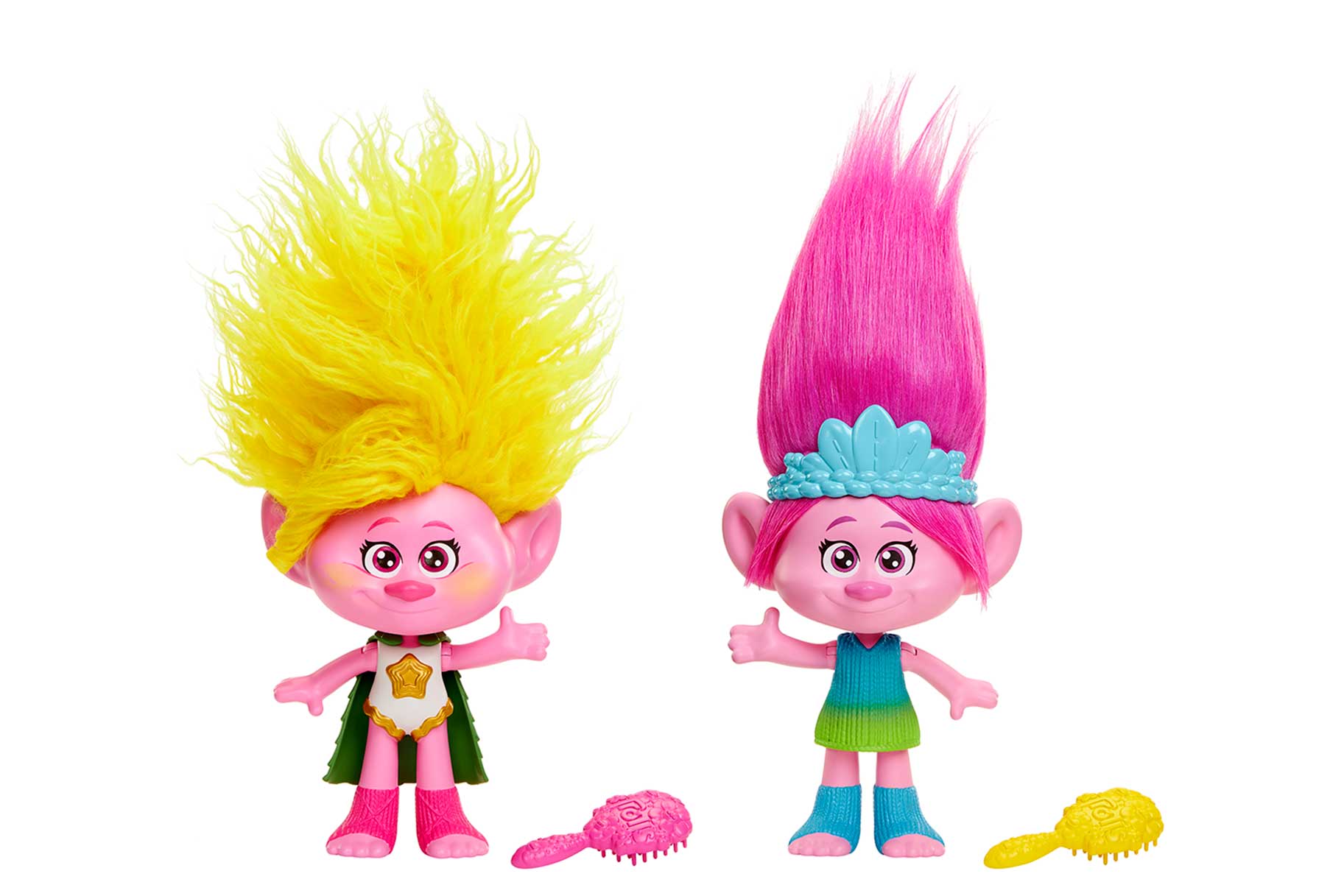Two Trolls dolls one with yellow hair (L) one with pink hair (R) with accessories scattered next to them.