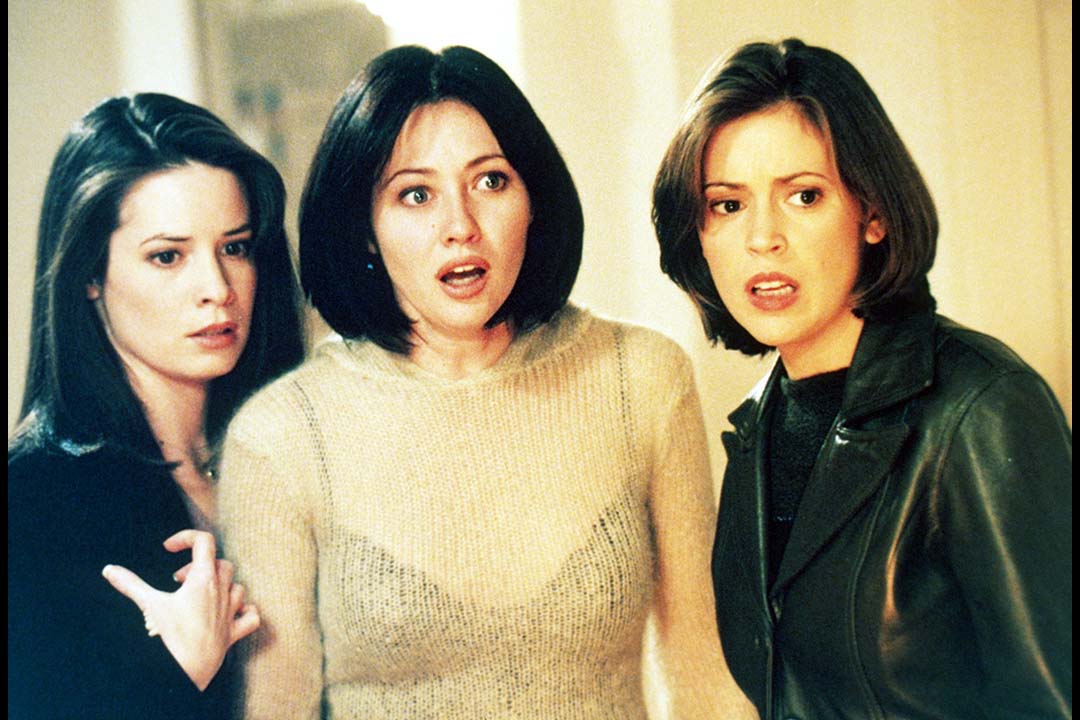 (L-R) Piper Halliwell (Holly Marie Combs), Prue Halliwell (Shannen Doherty), and Phoebe Halliwell (Alyssa Milano) look shocked in Charmed.