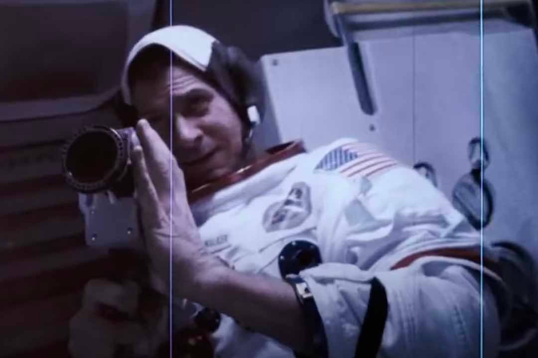 An astronaut (Jan Bos) holds a camera to his reflection in Apollo 18 (2011).